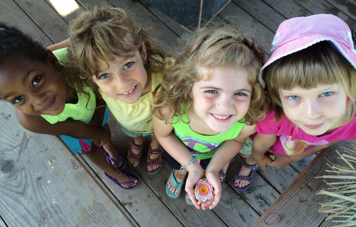Four children look up at the camera.