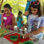 Children preparing food in the kid's kitchen.