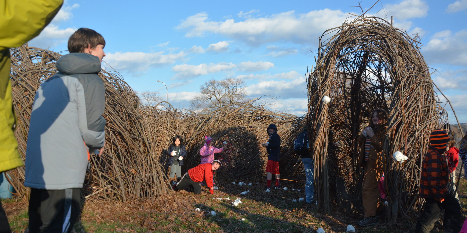 Children playing by the willow scultpure.