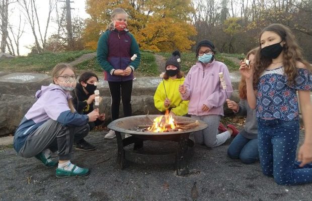 Gaia Circle gathered around a fire pit.