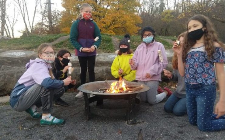 Gaia Circle gathered around a fire pit.