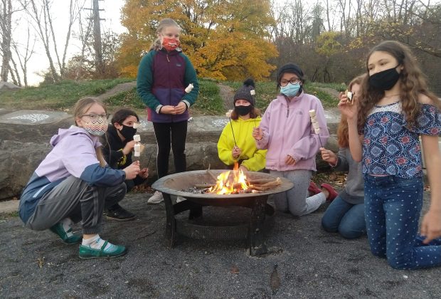 Gaia Circle gathered around a fire pit.
